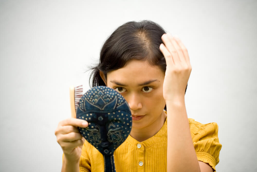 a woman looking in the mirror